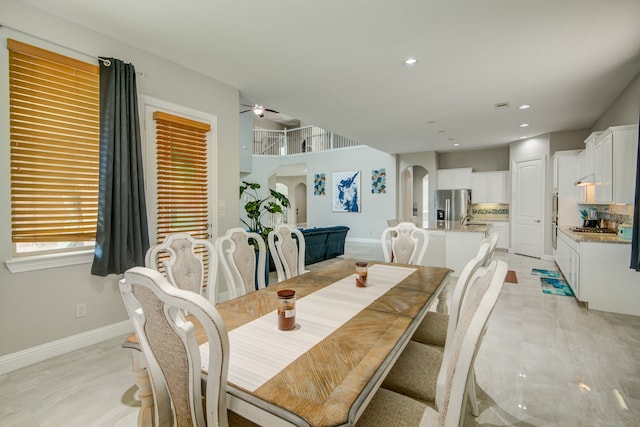 tiled dining room featuring sink and ceiling fan