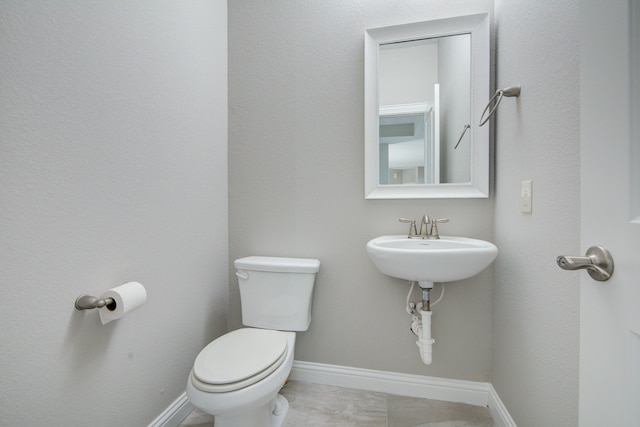 bathroom with toilet and tile patterned floors