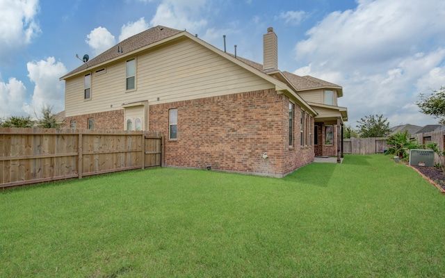 rear view of property with a yard