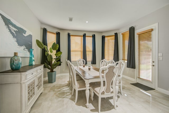 dining space featuring light tile patterned floors