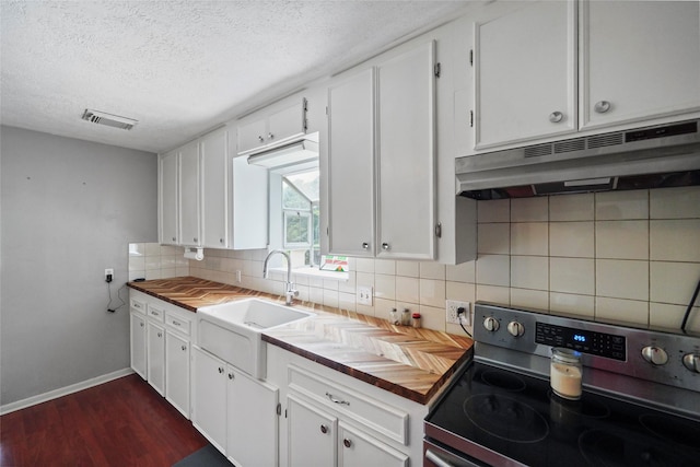 kitchen featuring stainless steel range with electric stovetop, decorative backsplash, a textured ceiling, and white cabinets