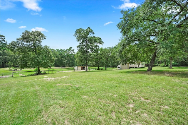 view of yard featuring a rural view and an outbuilding