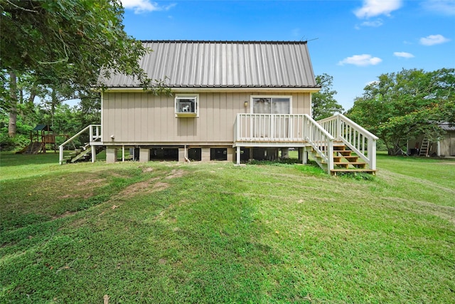 back of property with a yard and a playground