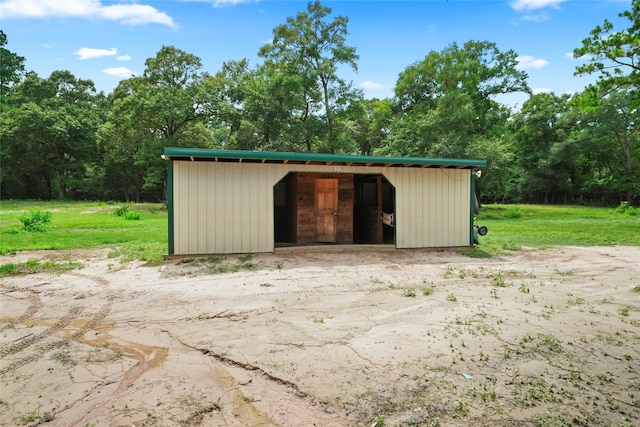 view of outdoor structure featuring a lawn