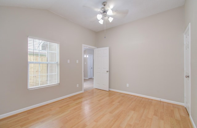 unfurnished room with ceiling fan, lofted ceiling, and light wood-type flooring