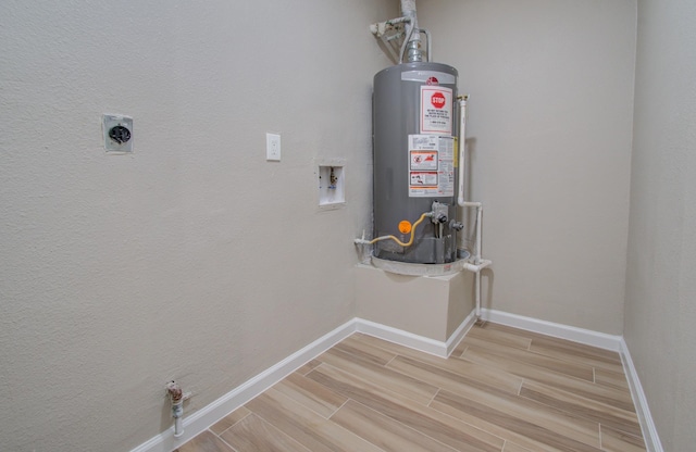 laundry room featuring electric dryer hookup, water heater, and hookup for a washing machine