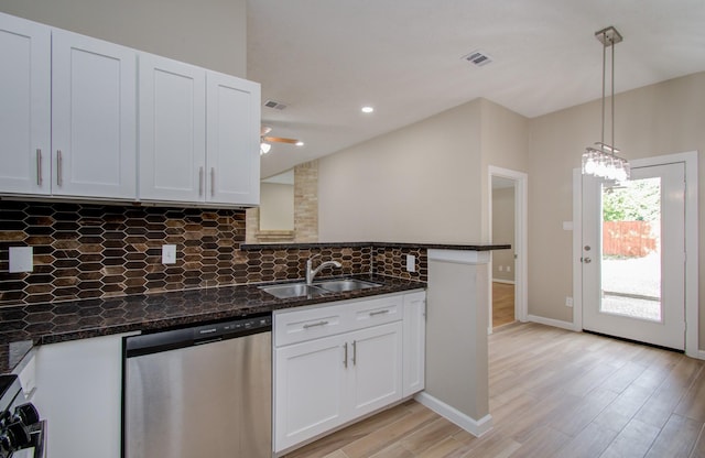 kitchen featuring sink, dishwasher, white cabinetry, and decorative light fixtures