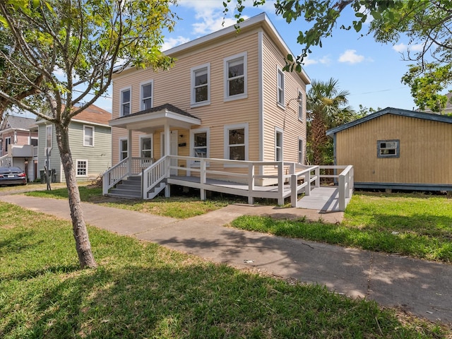 view of front of house featuring a deck and a front yard