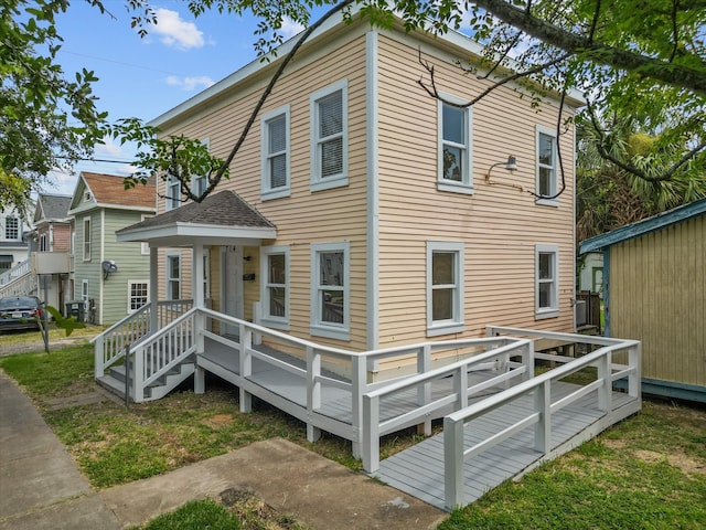 back of property with a deck