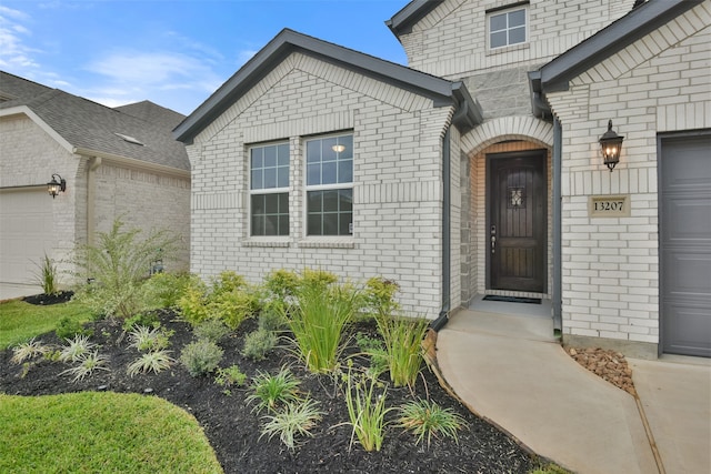 view of exterior entry featuring a garage