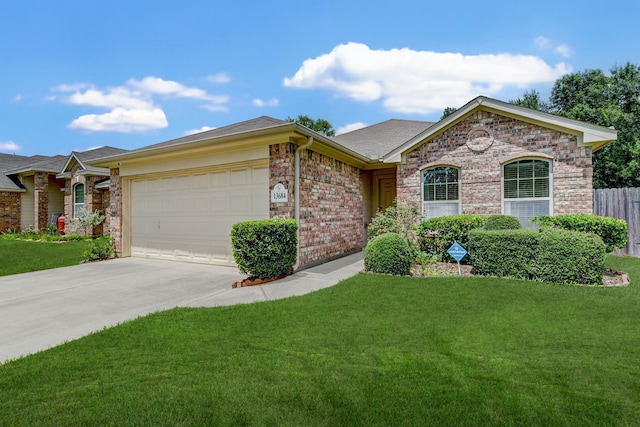 ranch-style home with a garage and a front lawn