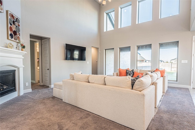 carpeted living room featuring a towering ceiling