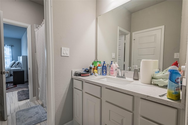 bathroom featuring curtained shower, hardwood / wood-style floors, and vanity