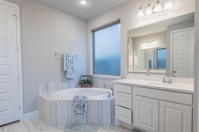 bathroom featuring a washtub and vanity