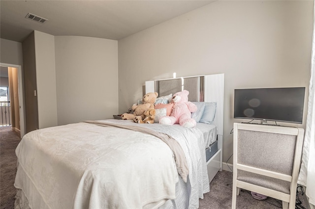 bedroom with dark colored carpet