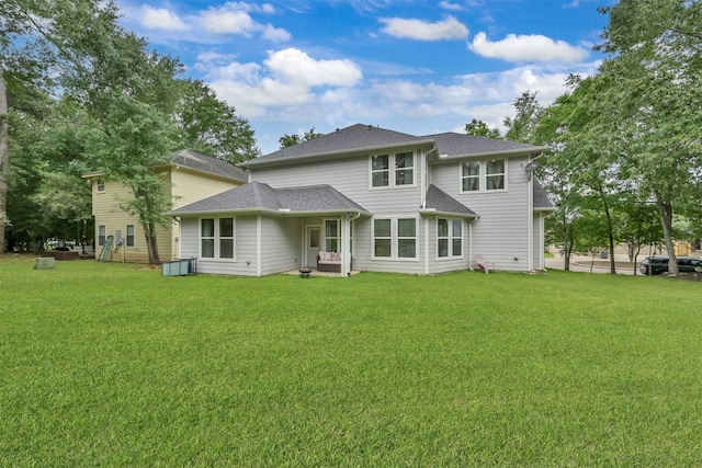 back of house with a lawn