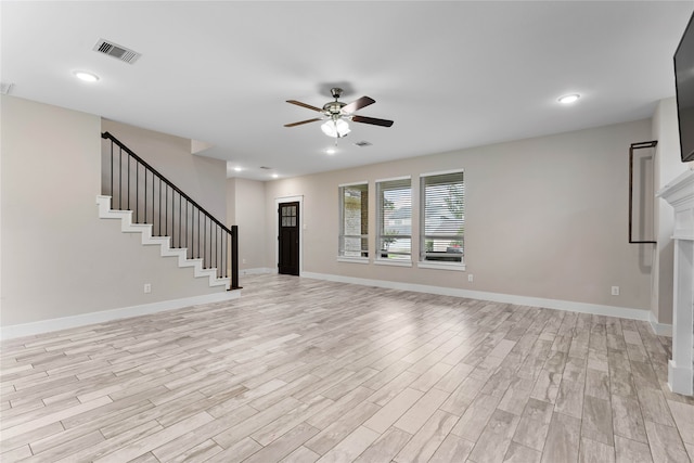 unfurnished living room featuring ceiling fan and light hardwood / wood-style floors