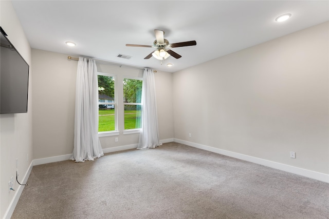 carpeted spare room with ceiling fan