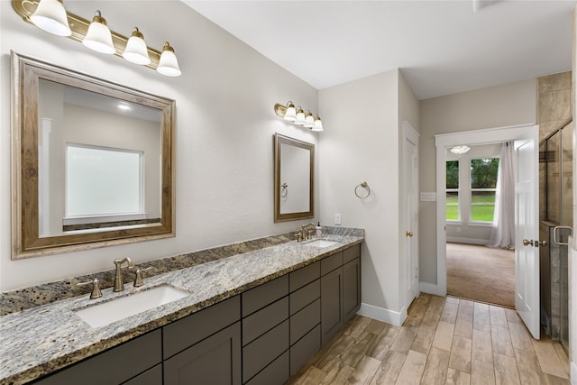 bathroom featuring vanity, a shower with shower door, and hardwood / wood-style flooring