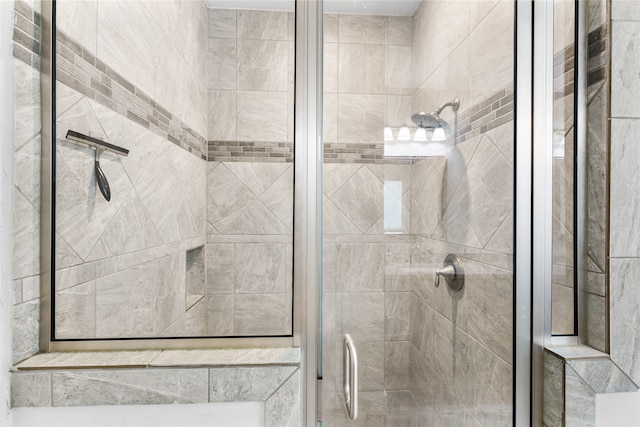 bathroom featuring a shower with door