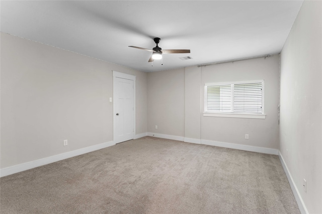 carpeted spare room featuring ceiling fan