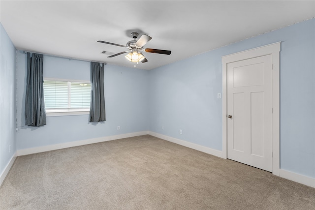 carpeted empty room featuring ceiling fan