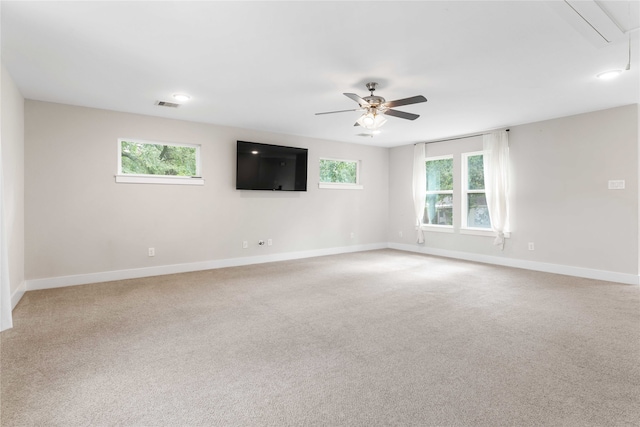 carpeted empty room with ceiling fan and a healthy amount of sunlight