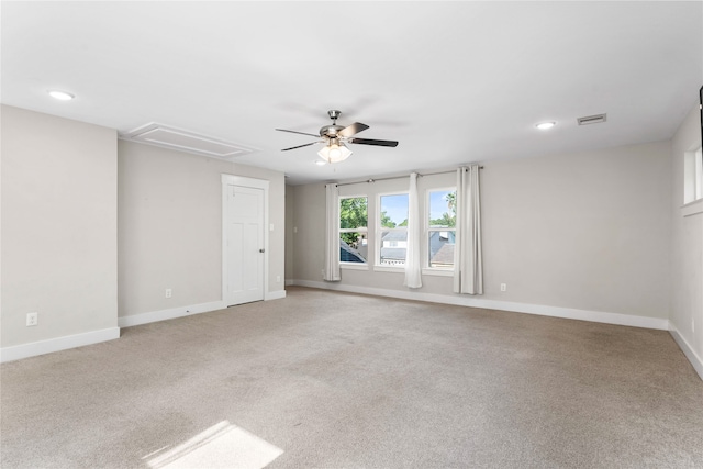 spare room featuring ceiling fan and light carpet