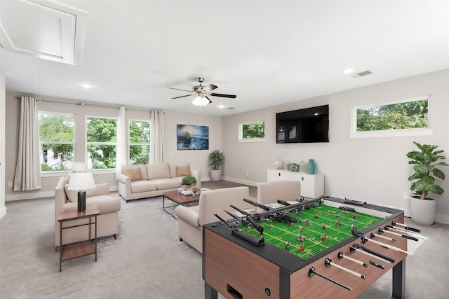 playroom with light carpet, plenty of natural light, and ceiling fan