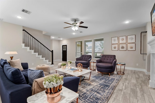 living room featuring ceiling fan and light hardwood / wood-style floors