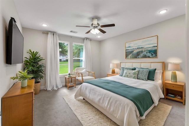 bedroom with ceiling fan and light colored carpet