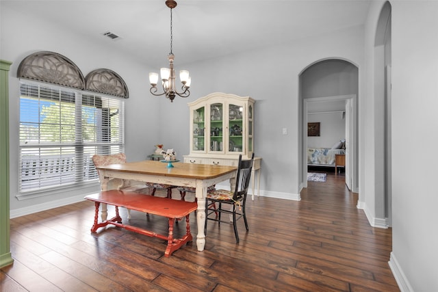 dining room featuring dark hardwood / wood-style flooring and a notable chandelier