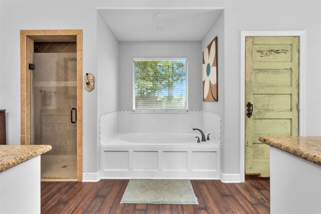 bathroom with separate shower and tub, wood-type flooring, and vanity