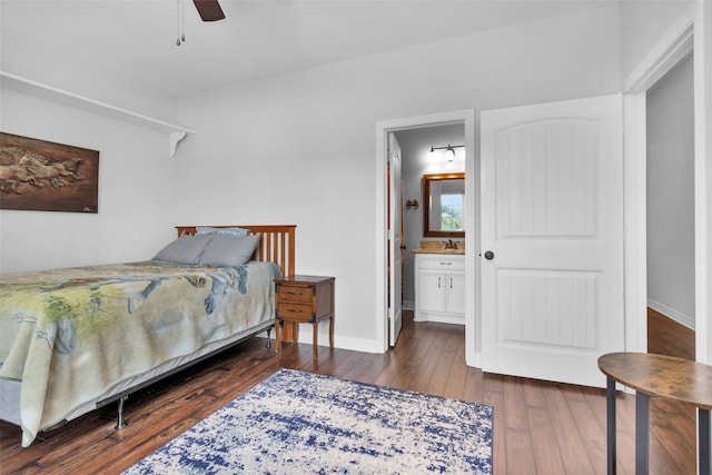 bedroom with sink, dark hardwood / wood-style flooring, ensuite bathroom, and ceiling fan