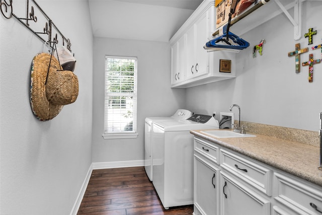 washroom featuring cabinets, dark hardwood / wood-style floors, washing machine and dryer, and sink