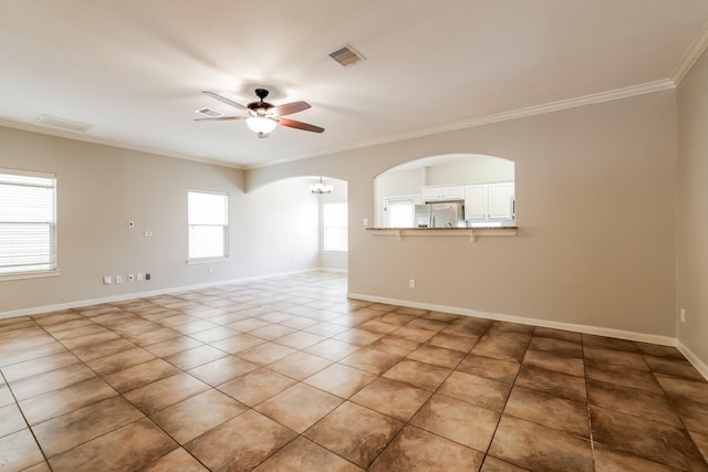 unfurnished room featuring ceiling fan, tile patterned floors, and ornamental molding