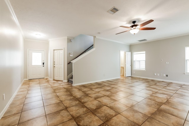 tiled entryway with ceiling fan and ornamental molding