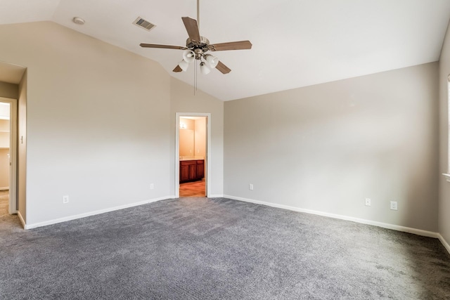 empty room with lofted ceiling, ceiling fan, and carpet flooring