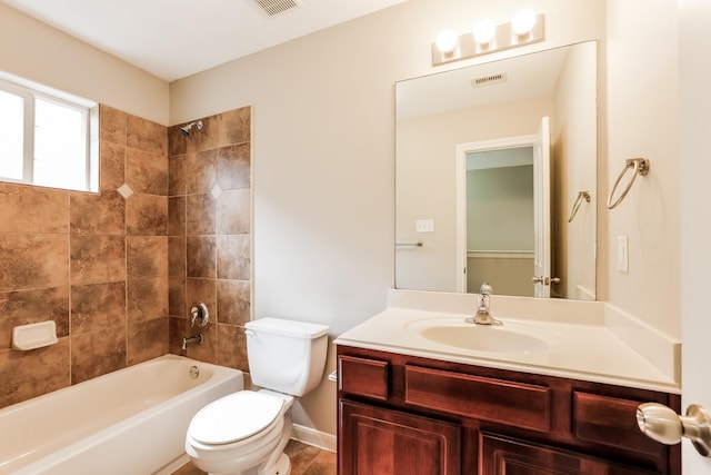 full bathroom featuring toilet, tiled shower / bath combo, and vanity