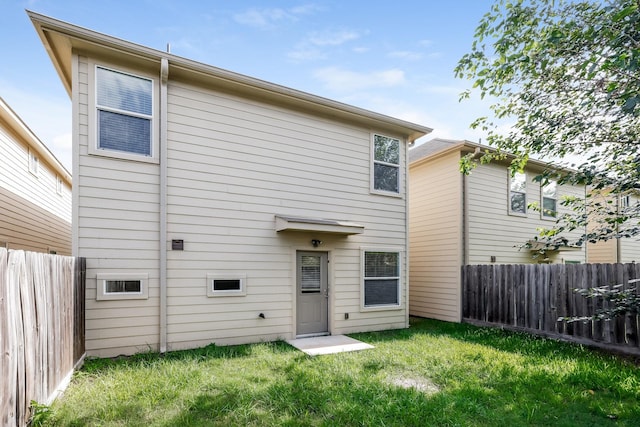 rear view of property with a lawn