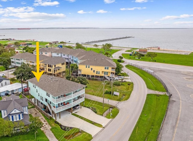 drone / aerial view with a water view and a residential view