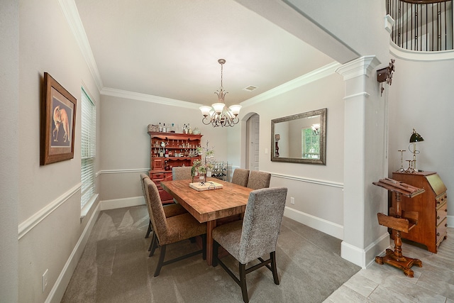 dining area featuring decorative columns, a chandelier, carpet flooring, and ornamental molding