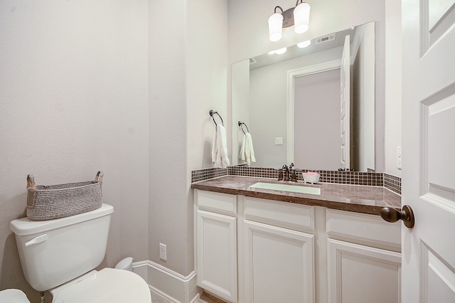 bathroom featuring toilet and vanity