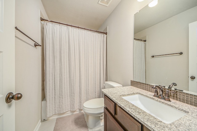 full bathroom featuring tile patterned floors, vanity, shower / bath combo, and toilet