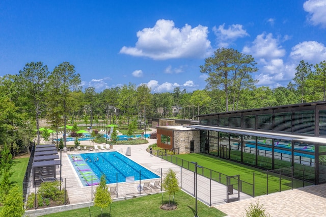 view of pool featuring a lawn