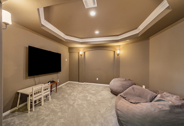 cinema room featuring a raised ceiling, crown molding, and carpet floors