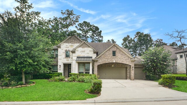 french provincial home featuring a garage and a front lawn