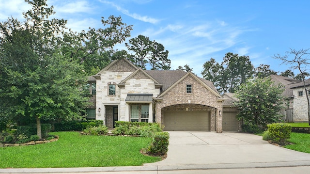 french country inspired facade with driveway, a front lawn, roof with shingles, a garage, and brick siding