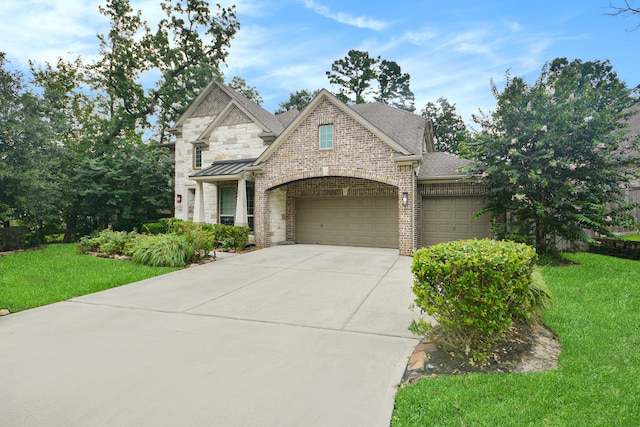 view of front of home featuring a garage and a front lawn