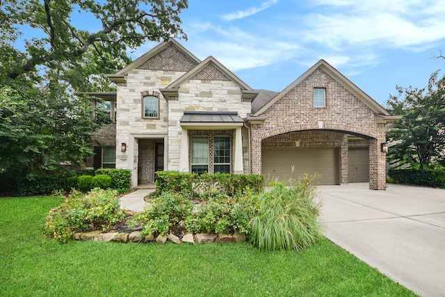 french provincial home featuring a front lawn, stone siding, concrete driveway, a garage, and brick siding